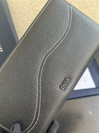 Dior small leather zip wallet bag side detail with stitched seam and Dior mark
