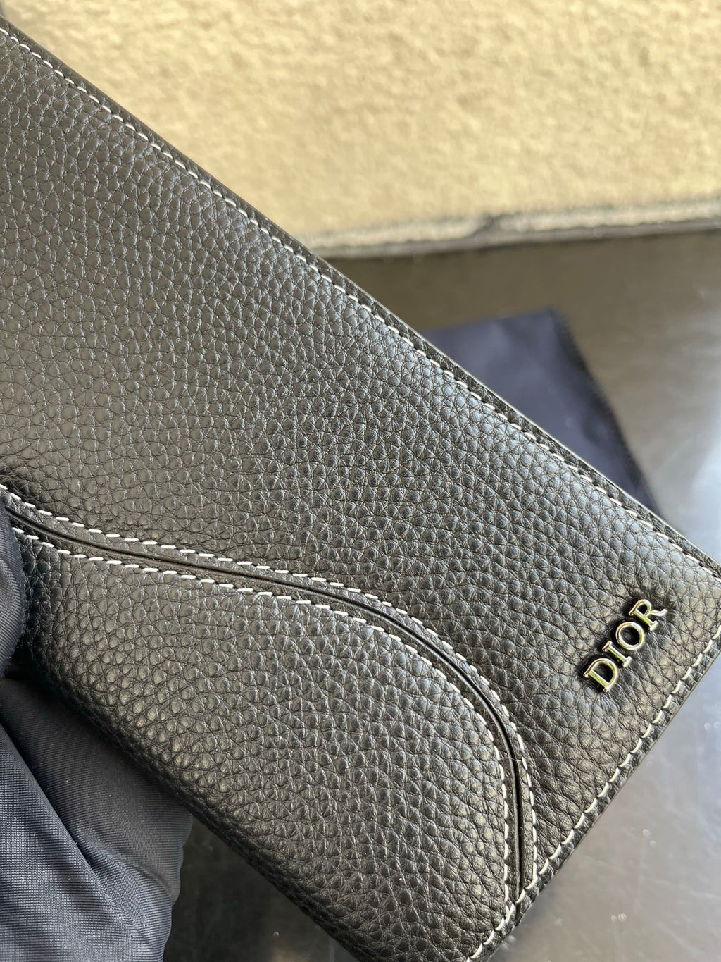 Small bag card holder section with stitched pocket and Dior logo on dark leather