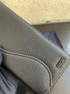 Small bag card holder section with stitched pocket and Dior logo on dark leather