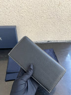 Small bag in dark gray pebbled leather with curved flap detail and Dior logo
