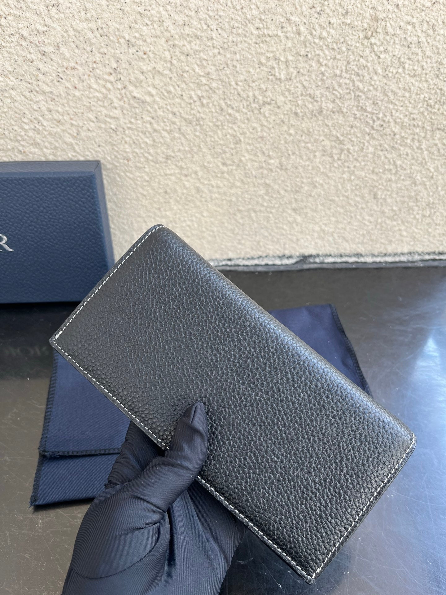 Small bag in dark gray pebbled leather with curved flap detail and Dior logo