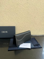Small bag in dark gray textured leather, folded front view with Dior branding