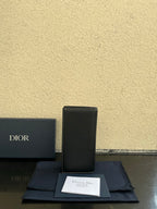 Small bag in dark gray textured leather, upright view with Dior logo on front