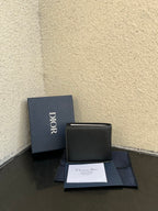 Dior small leather card wallet with flap, textured dark finish and Dior logo.