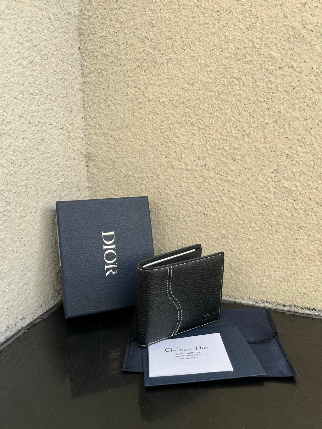 Dior small leather card wallet, compact flap style with stitched trim and Dior branding.