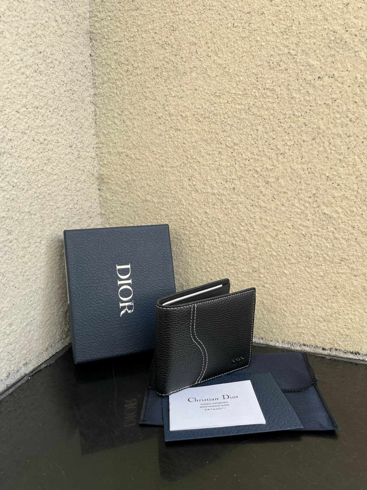 Dior small leather card wallet, compact flap style with stitched trim and Dior branding.