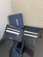 Dior small leather wallet open, multiple card slots with Dior print on center panel.