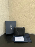 Dior small leather card wallet, textured dark color with stitched edge and logo.
