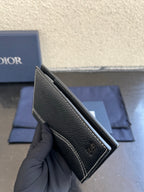 Dior card holder in dark textured leather, open side view with interior lining.