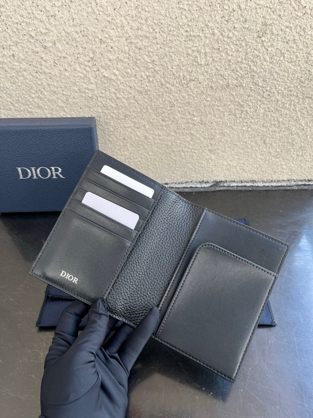 Dior small bag open view with card slots and grained leather pockets