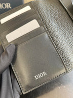 Dior card holder interior with multiple card slots and stitched edges, dark leather.