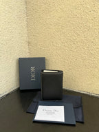 Small bag with dark leather wallet, Dior logo, and gift box with papers
