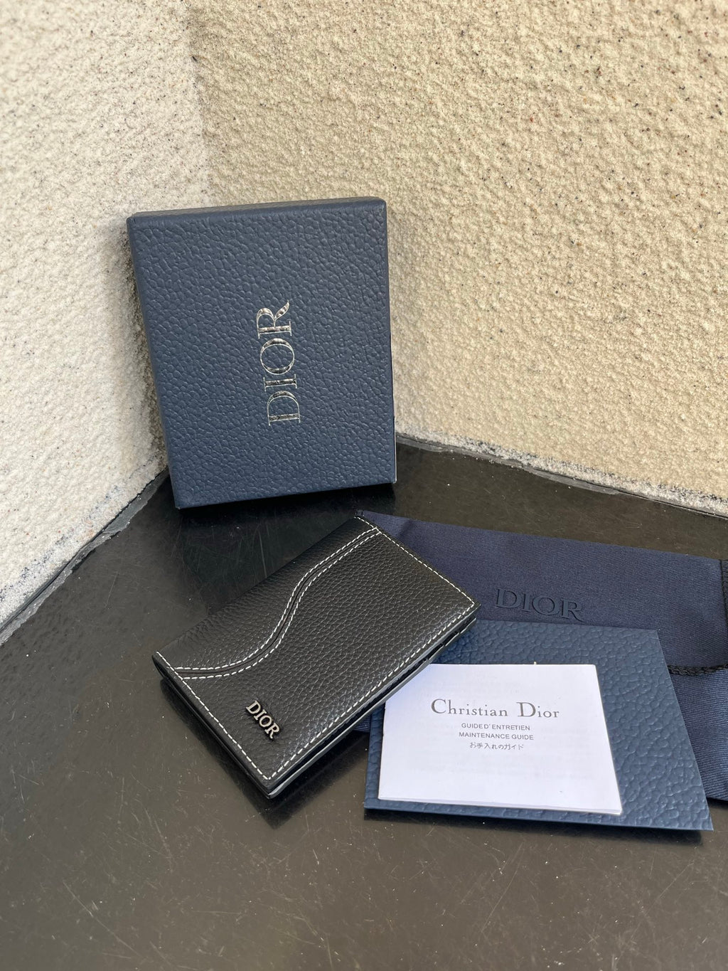 Small bag with dark leather fold wallet, Dior box, and included card insert
