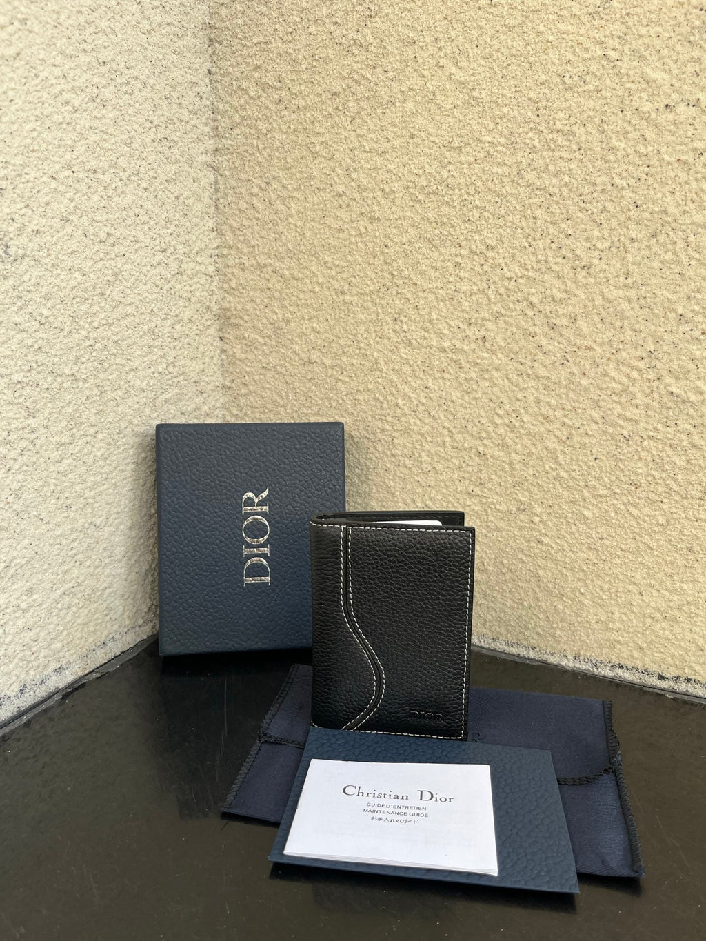 Small bag set with dark leather-style wallet and Dior box, papers