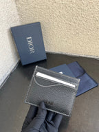 Dior card holder with front logo and silver top edge, textured dark leather