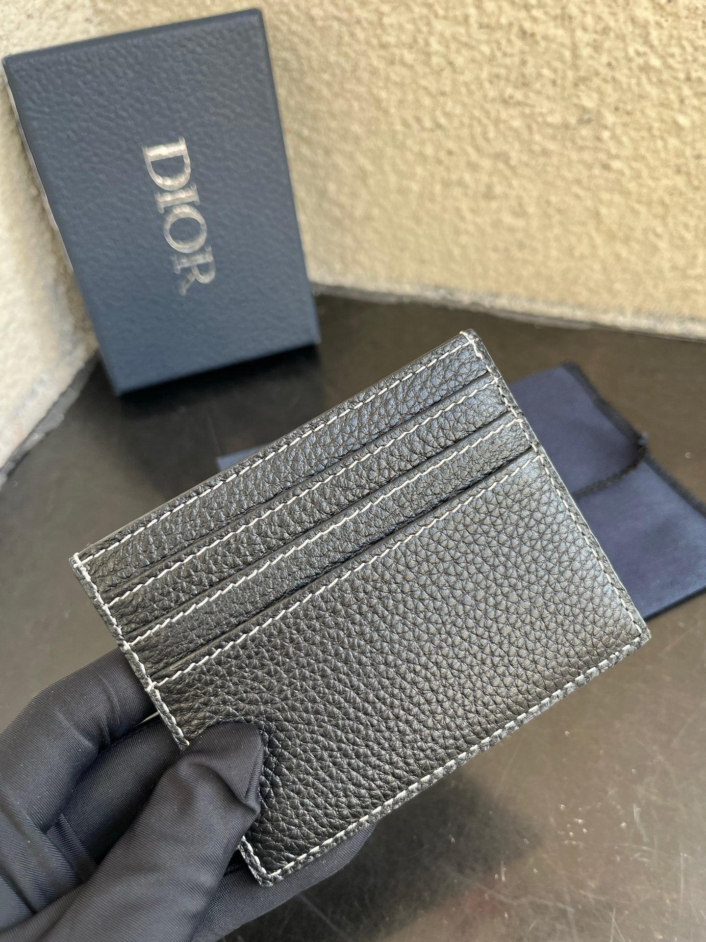 Dior card holder with three card slots, textured dark leather and silver stitching