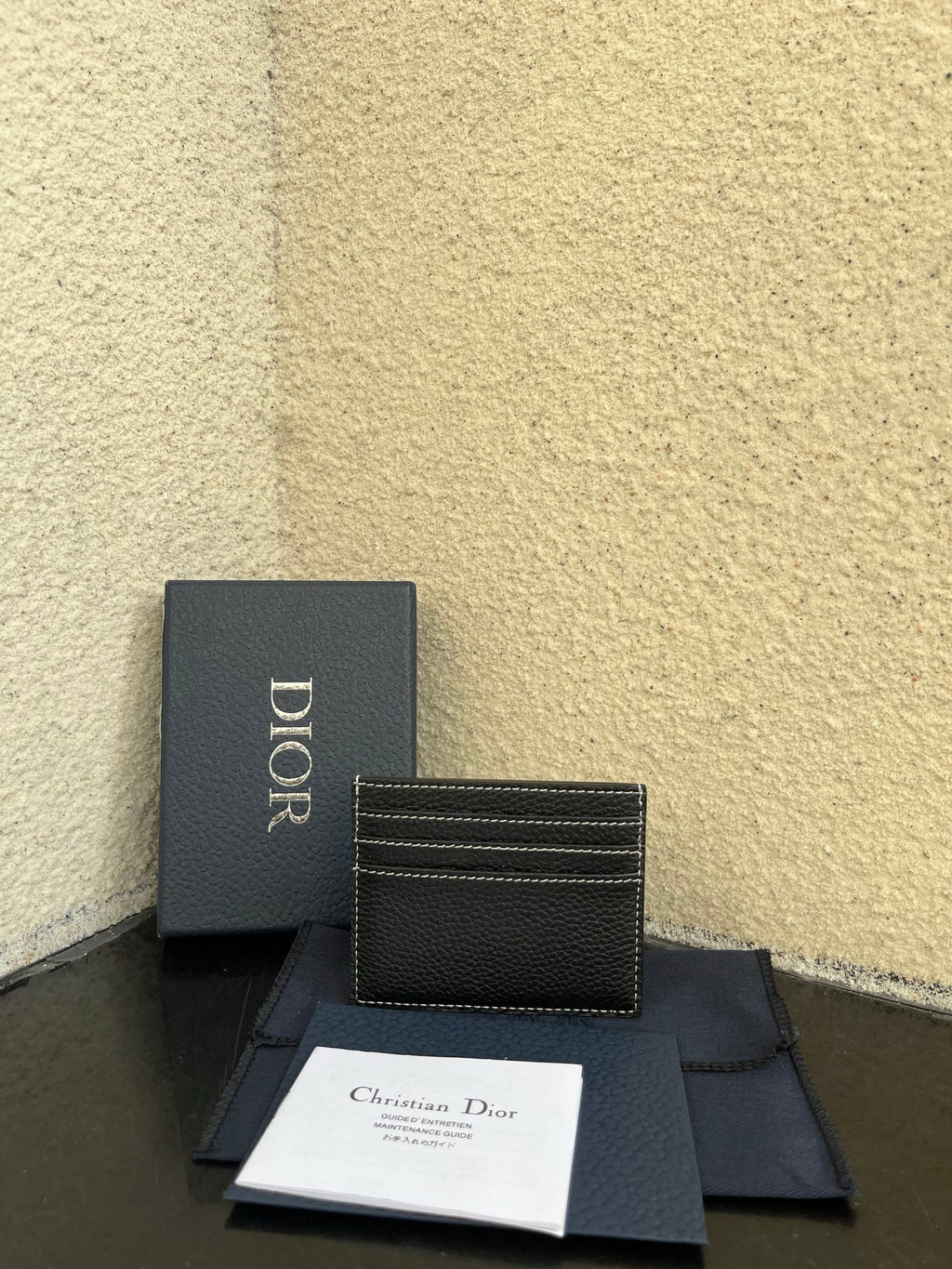Dior card holder with logo panel and multiple card slots, dark textured leather