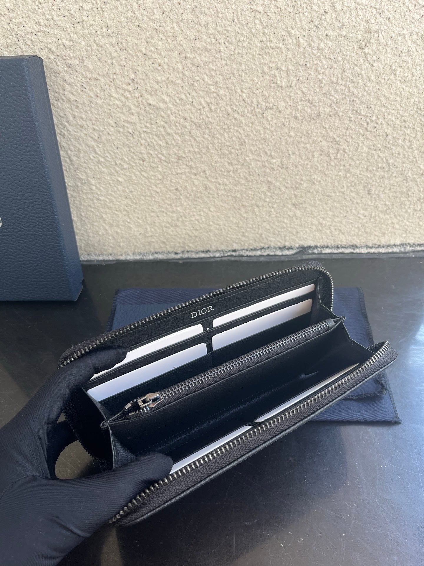 Small Dior bag open view with interior slots and top zipper closure