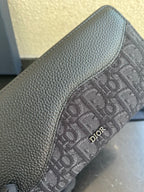 Small Dior monogram canvas bag detail with embossed fabric and Dior logo