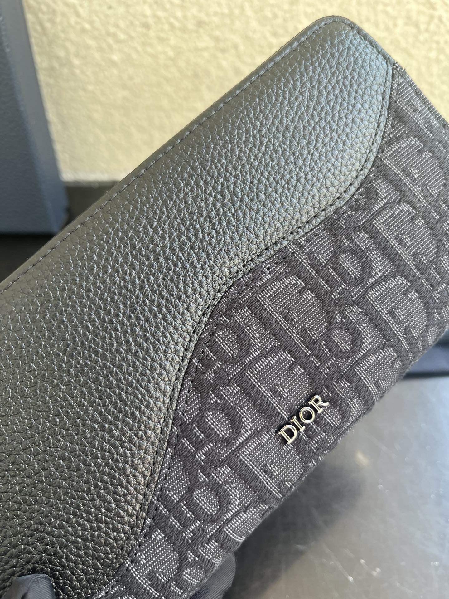 Small Dior monogram canvas bag detail with embossed fabric and Dior logo