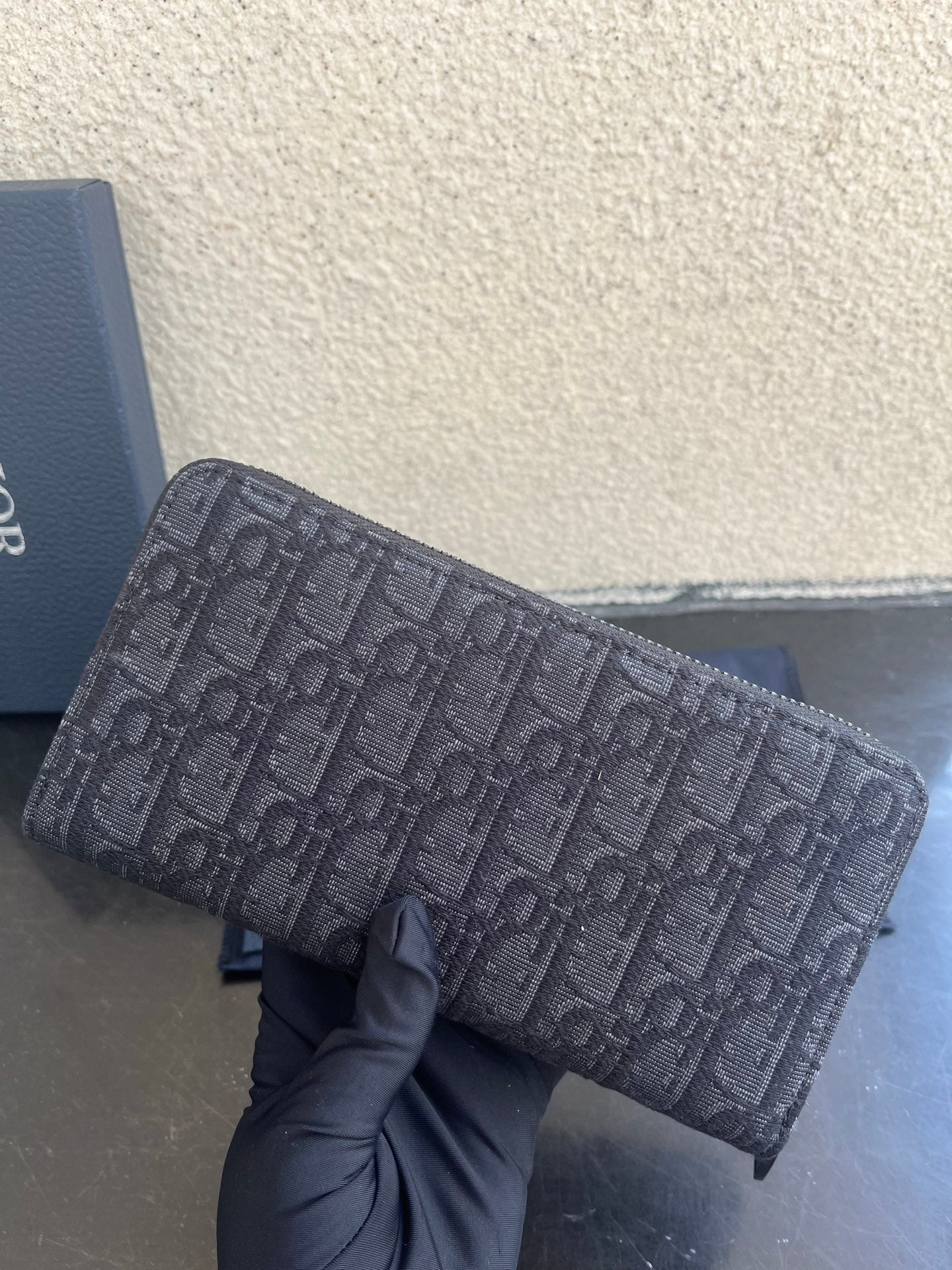 Small Dior monogram canvas bag with top zipper and textured strap ends