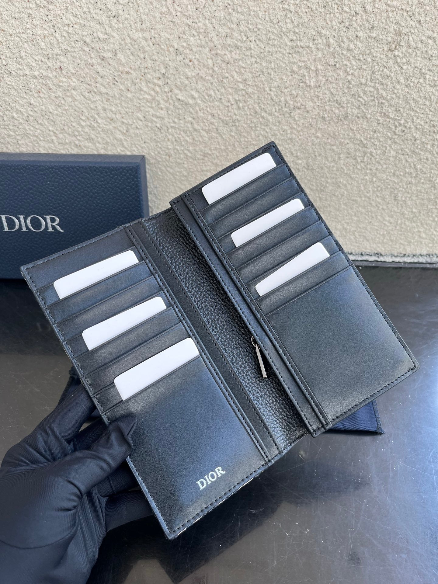 Small bag card holder open with multiple slots and white cards, dark leather
