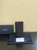 Small bag card holder in dark textured leather with Dior logo, front view