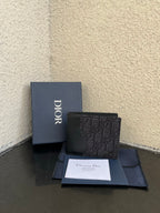 Dior small bag wallet in dark monogram canvas, front view with snap closure