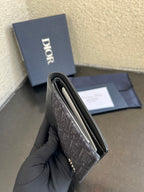 Dior small bag wallet held in profile, dark monogram fabric exterior