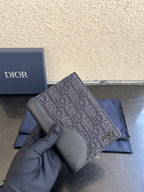 Dior small bag close-up with gray monogram fabric and grained leather front