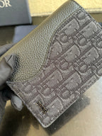 Dior small bag close-up showing embossed monogram and textured leather border