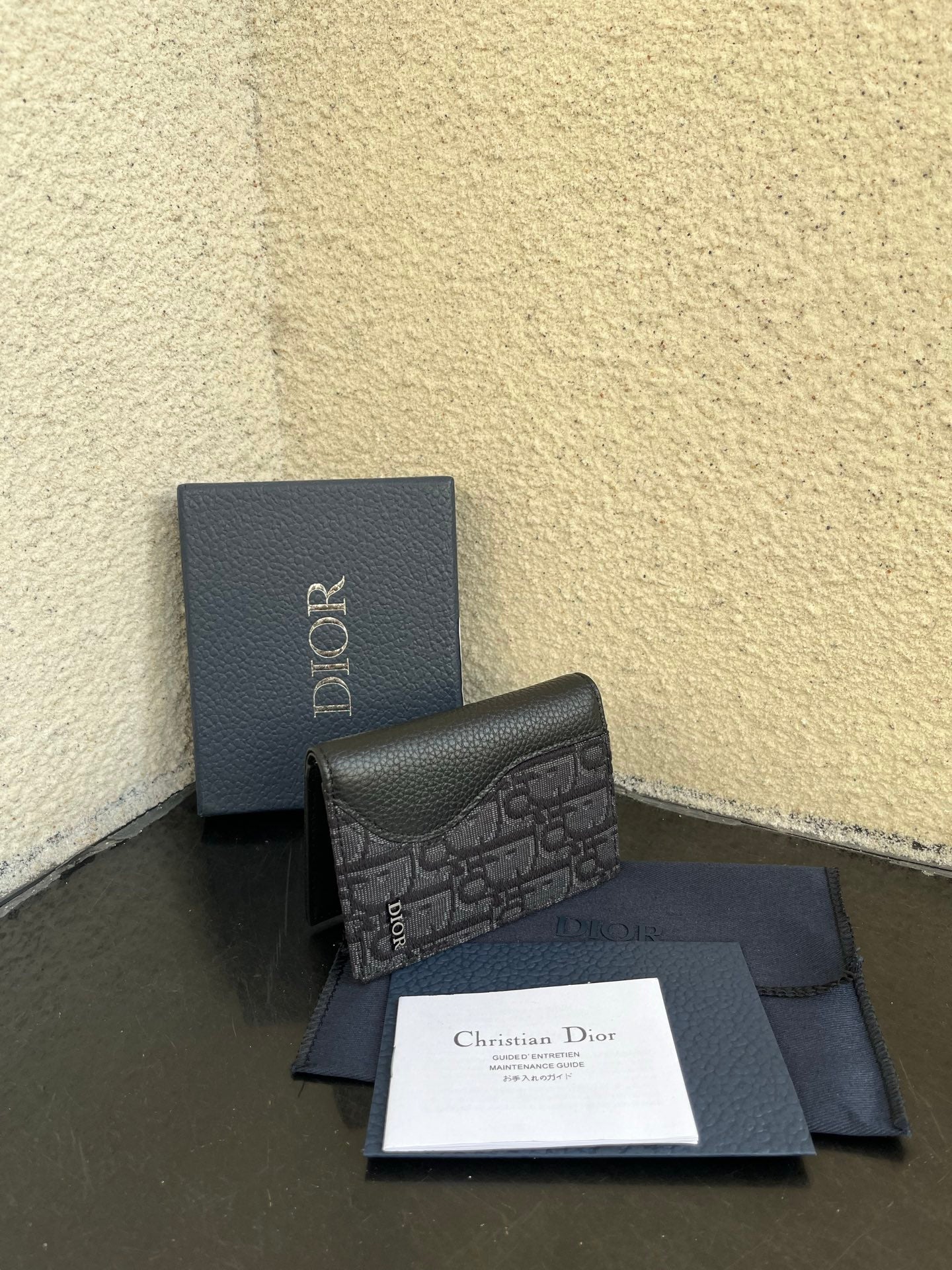 Dior small bag with patterned leather front and dark box, with papers and sleeve