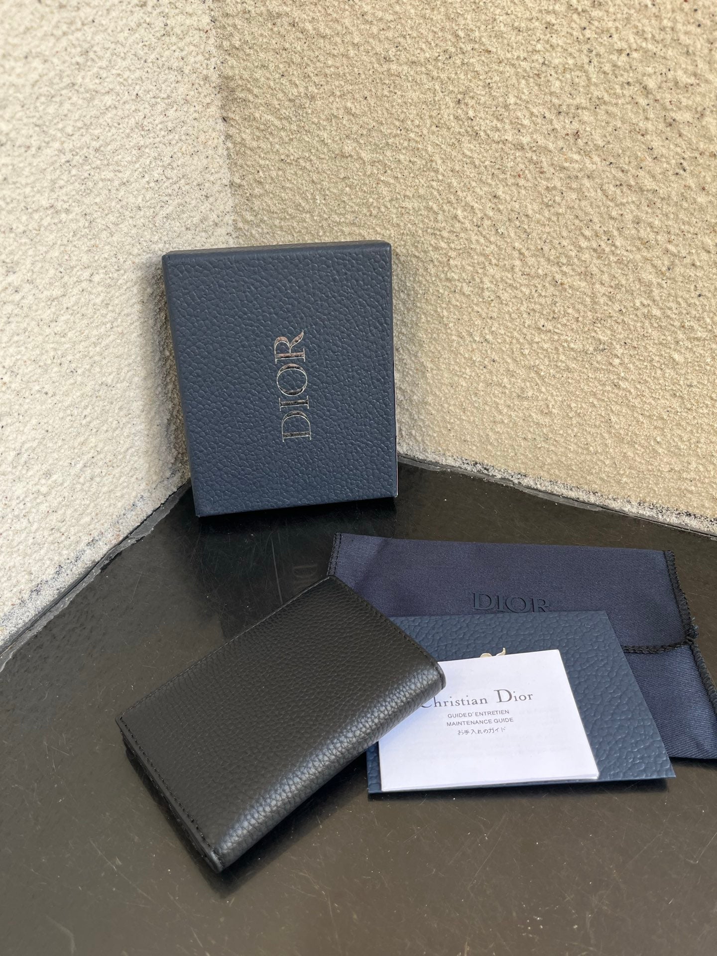 Dior small bag with smooth dark wallet design, with papers and matching box