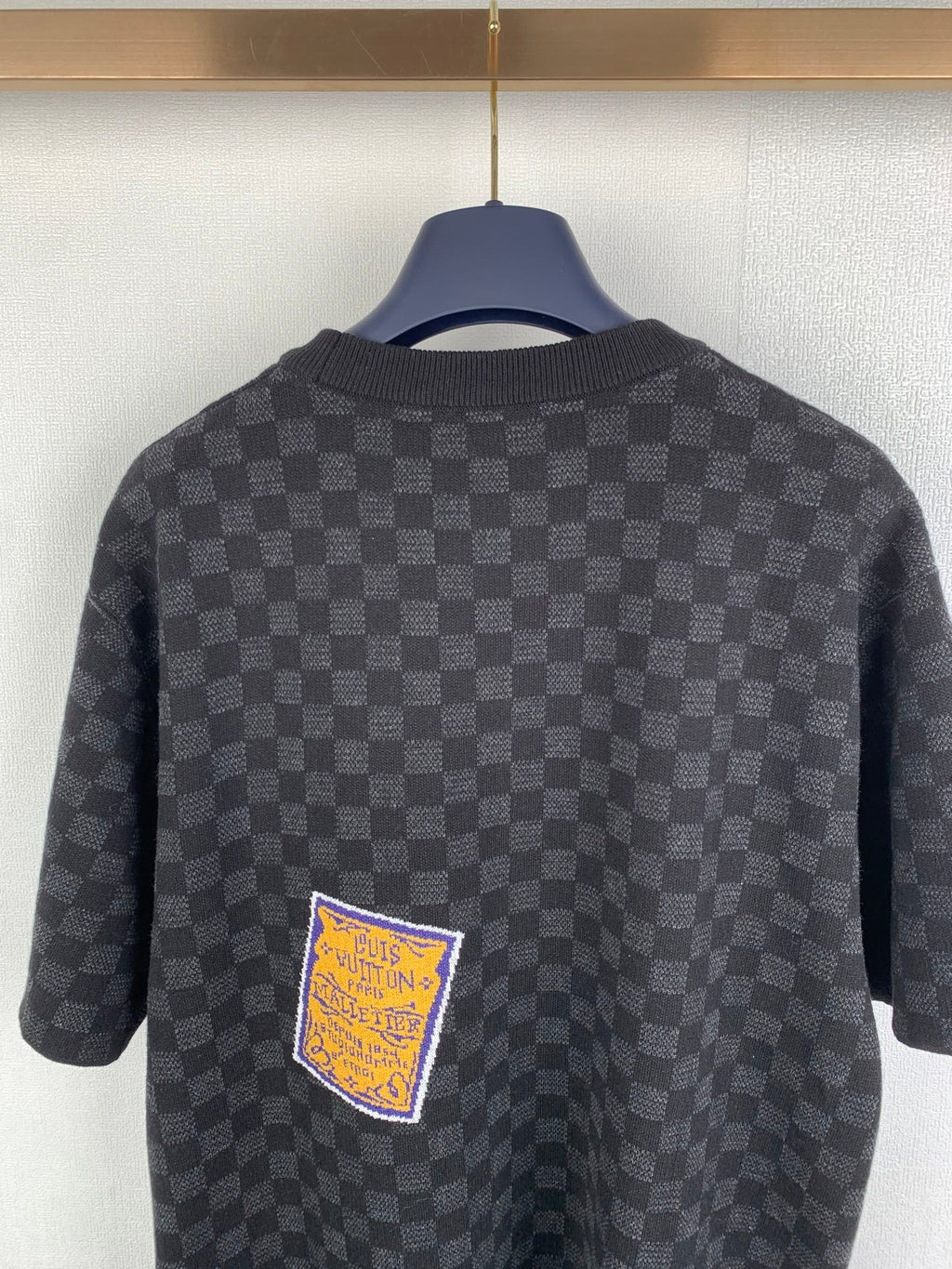 Black check short-sleeve T-shirt back view with embroidered square patch