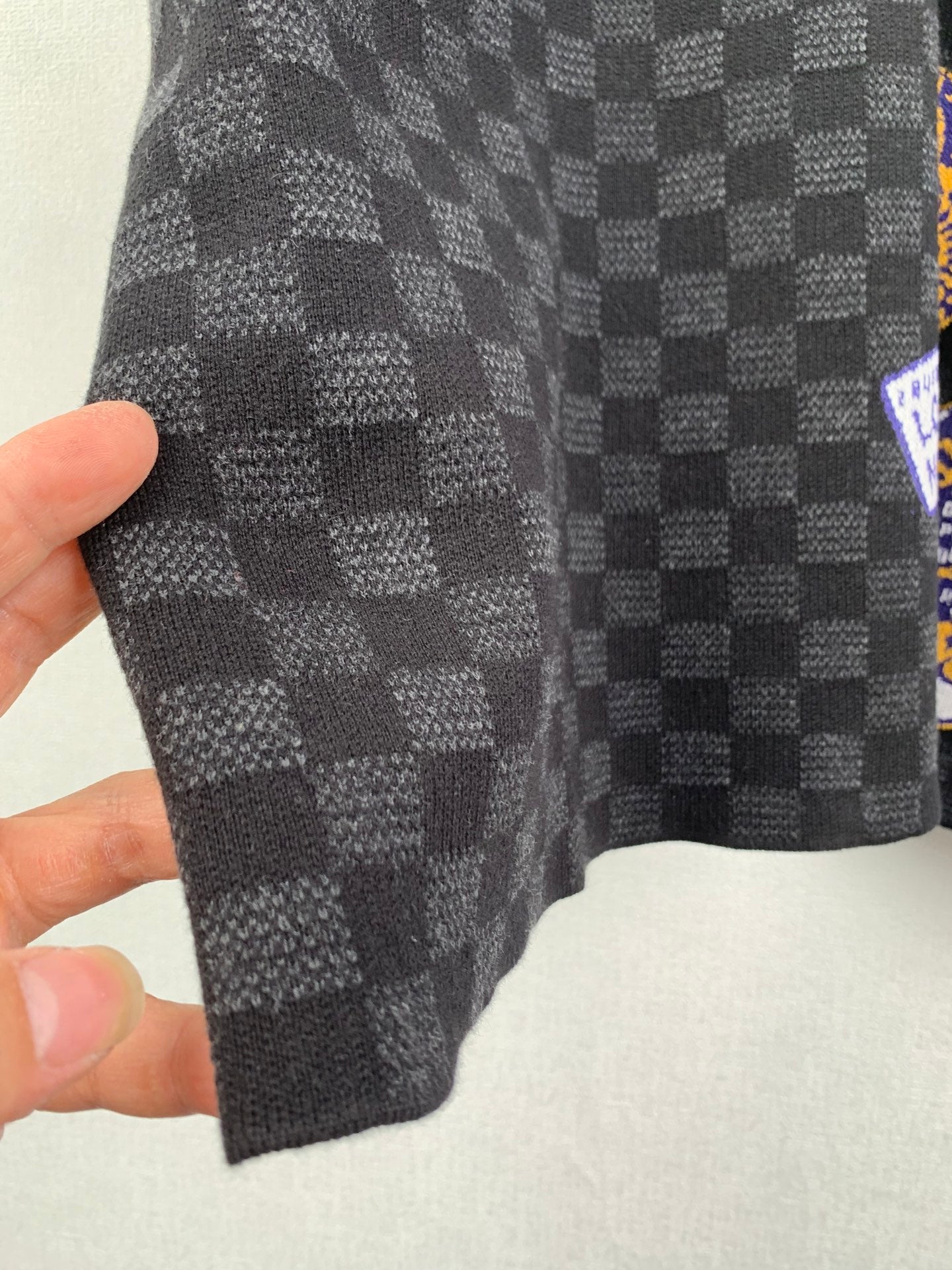 Black check short-sleeve T-shirt fabric close-up showing checker pattern