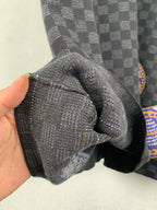 Black check short-sleeve T-shirt sleeve cuff close-up in textured knit