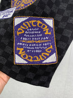 Louis Vuitton shorts with blue-and-gold logo patch on black check fabric