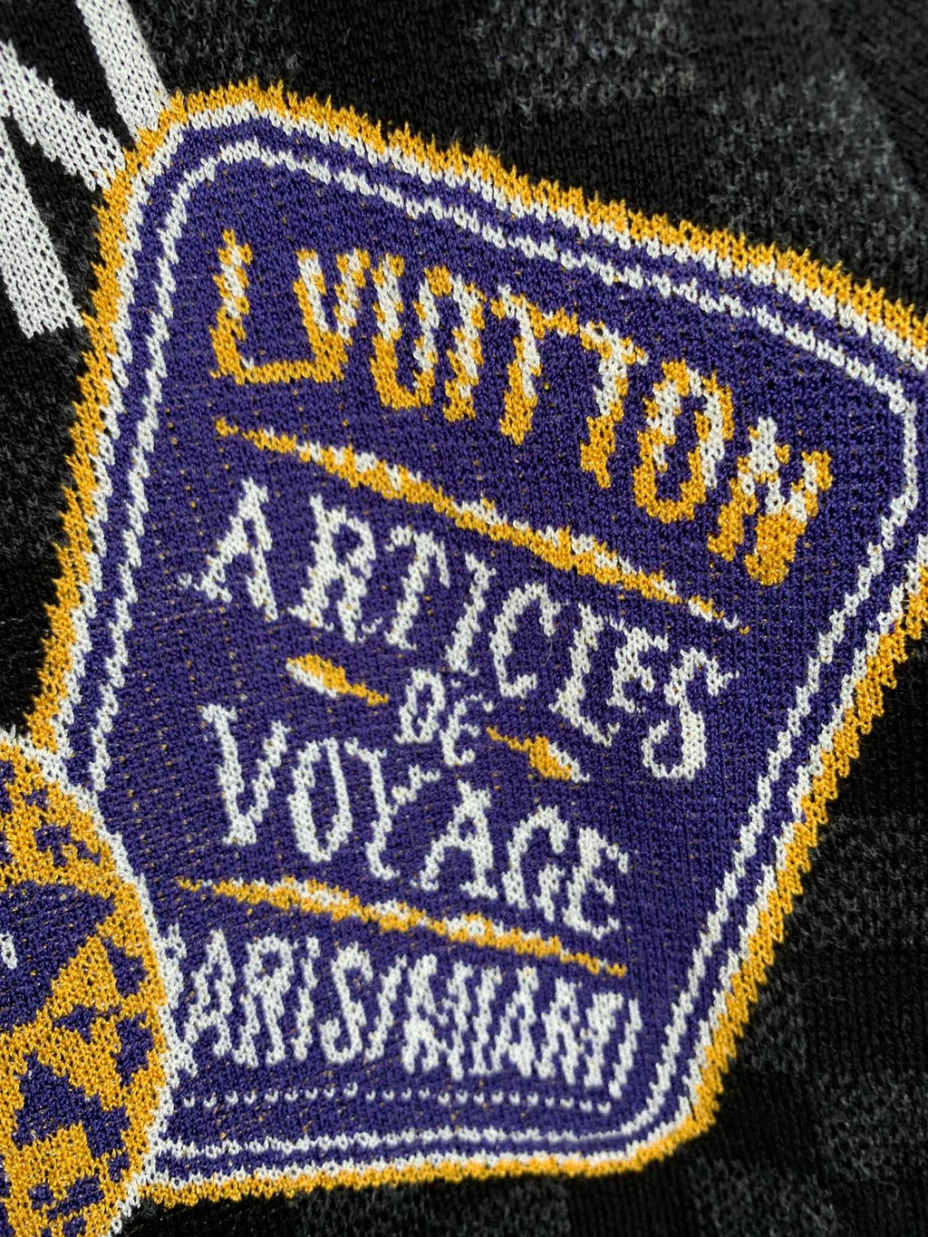 Black check short-sleeve T-shirt close-up of embroidered square patch detail
