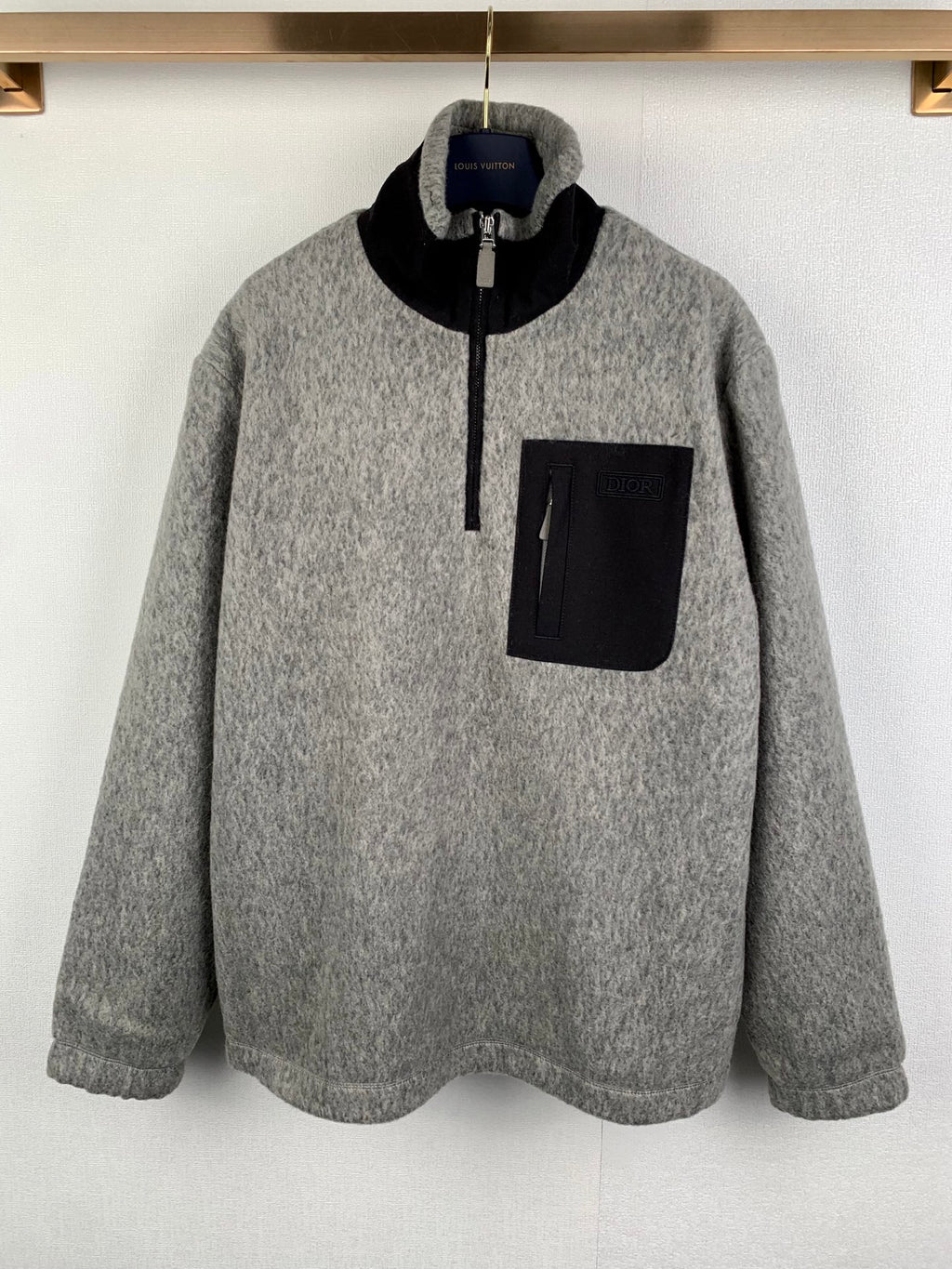 Gray long-sleeve zip jacket with black collar and chest pocket