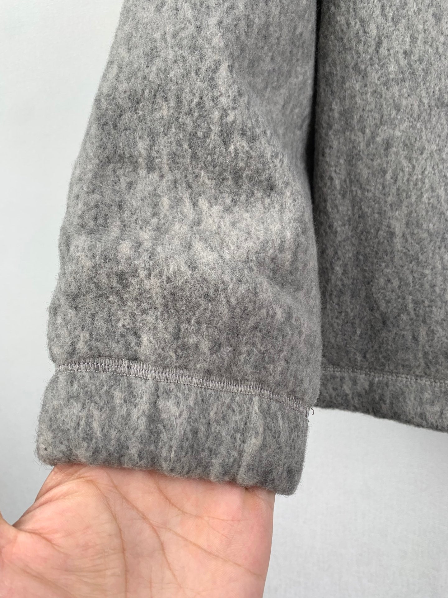 Gray long-sleeve jacket sleeve cuff with stitched hem