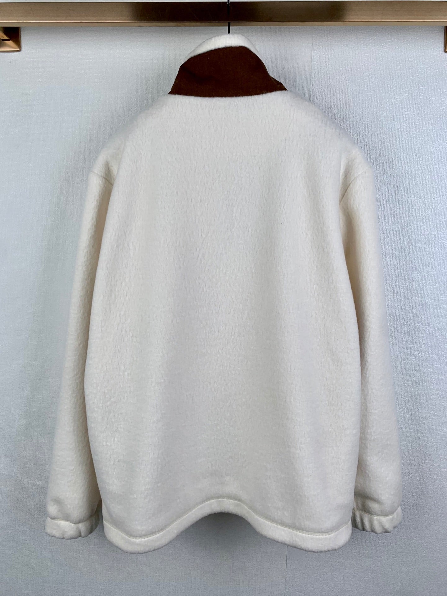 Cream fleece quarter-zip jacket back view with brown stand collar
