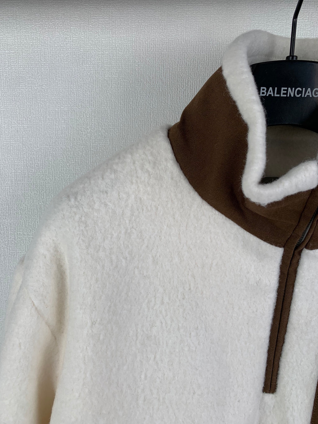 Cream fleece quarter-zip jacket with brown stand collar and zip front