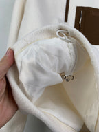 Cream fleece jacket hood lining with drawstring cord and stopper