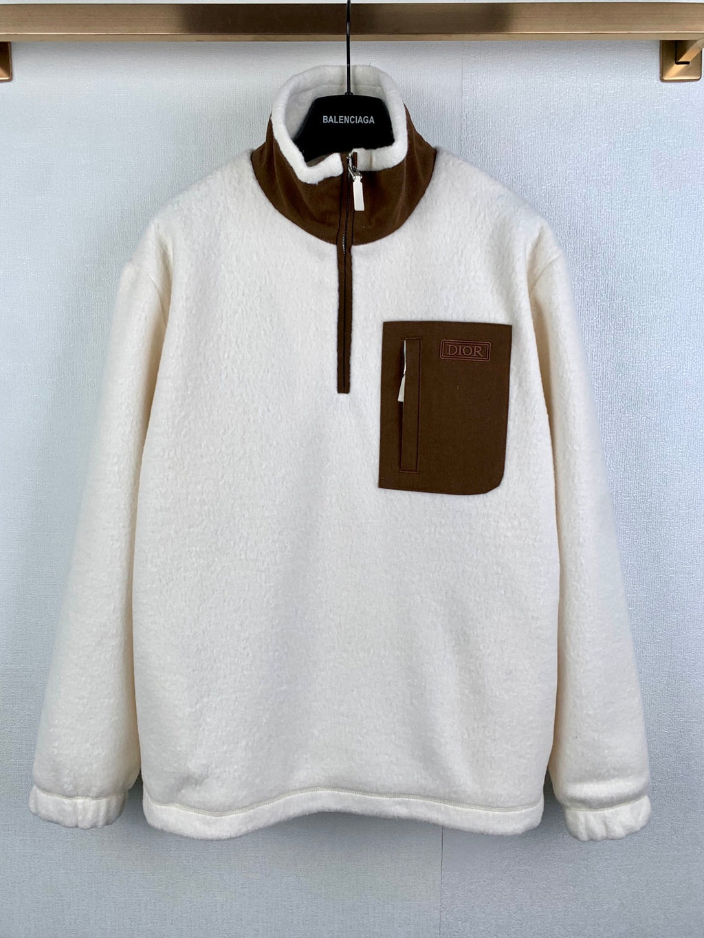 Cream fleece quarter-zip jacket with brown contrast collar and chest pocket