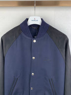 Dark navy and gray raglan jacket, stand collar, snap front buttons, buttoned chest details