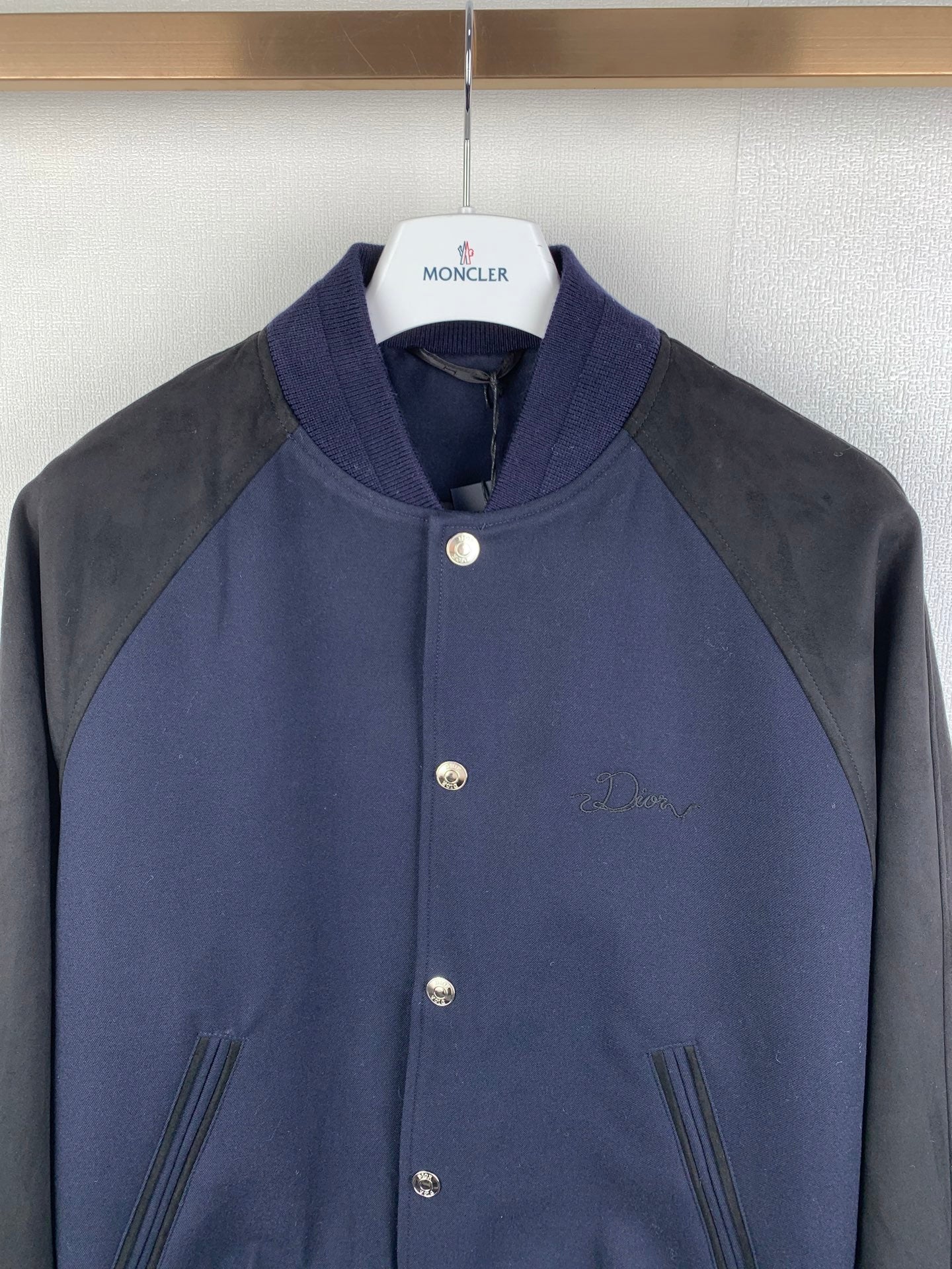 Dark navy and gray raglan jacket, stand collar, snap front buttons, buttoned chest details
