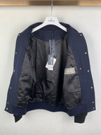 Navy jacket with black lining, snap buttons, and interior pocket