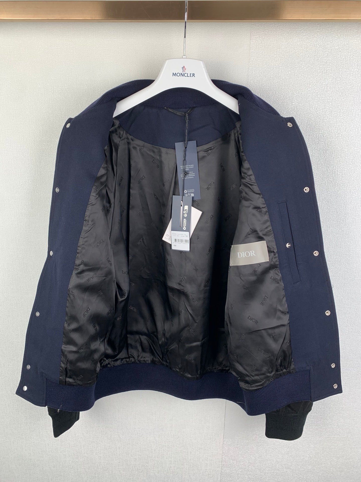 Navy jacket with black lining, snap buttons, and interior pocket