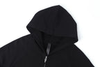 Dark zip-up hoodie with hood and metal zipper, close-up view