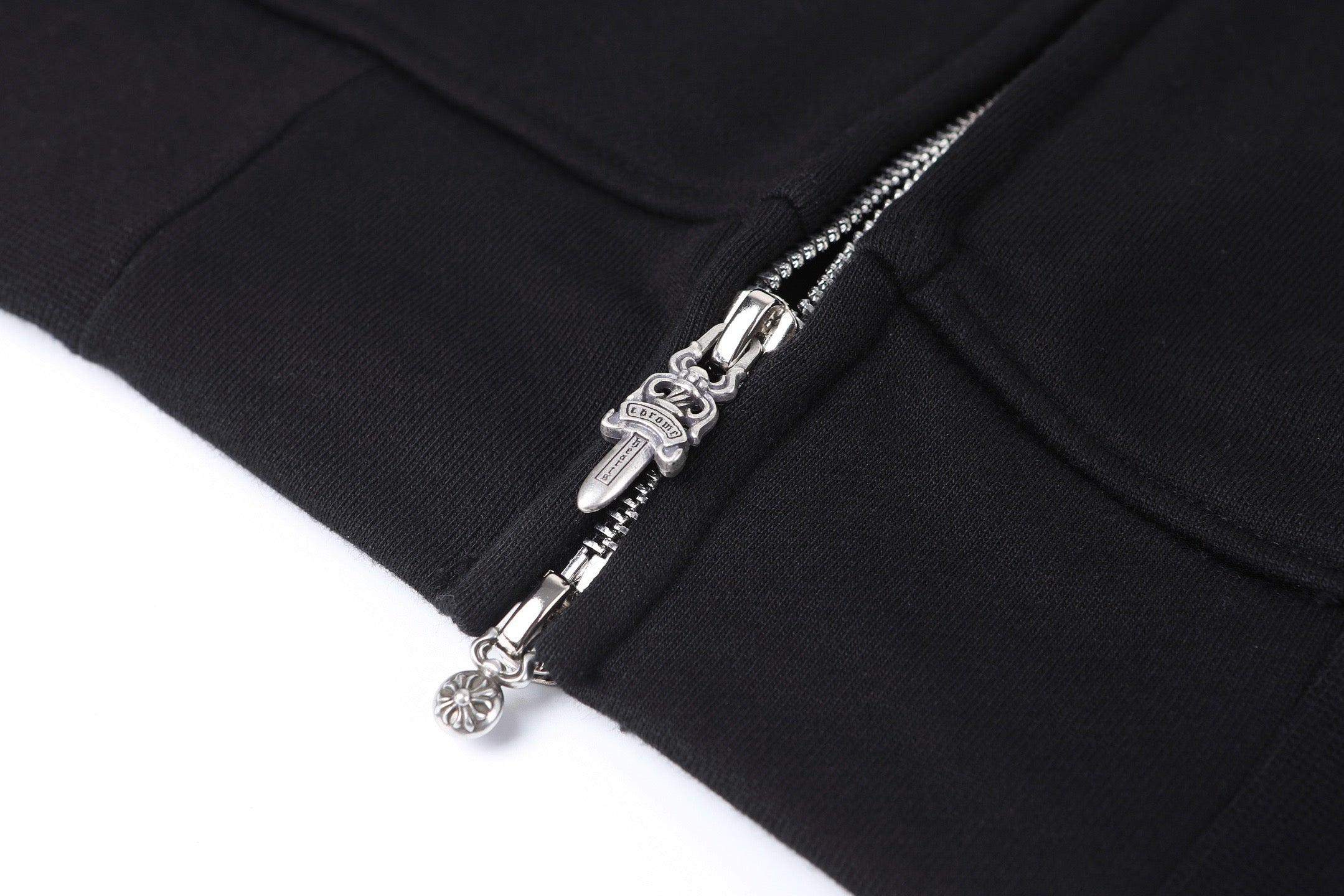 Dark hoodie with silver metal zipper and decorative zipper pull